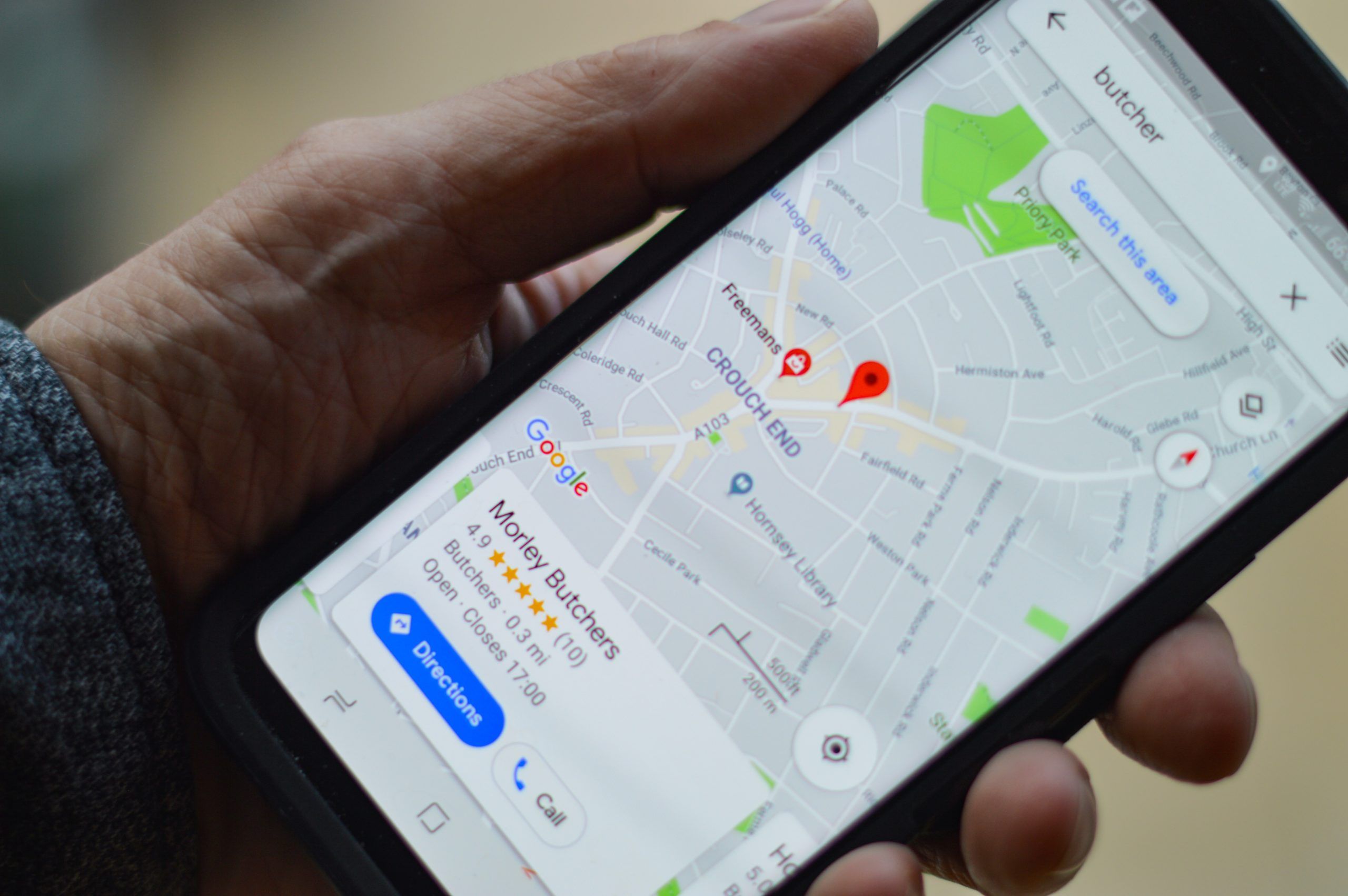 Smartphone Display mit Google Maps ansicht und einer Adresse.